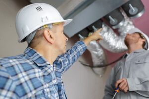 photodune manager giving orders to coworkers fixing air conditioning xxl